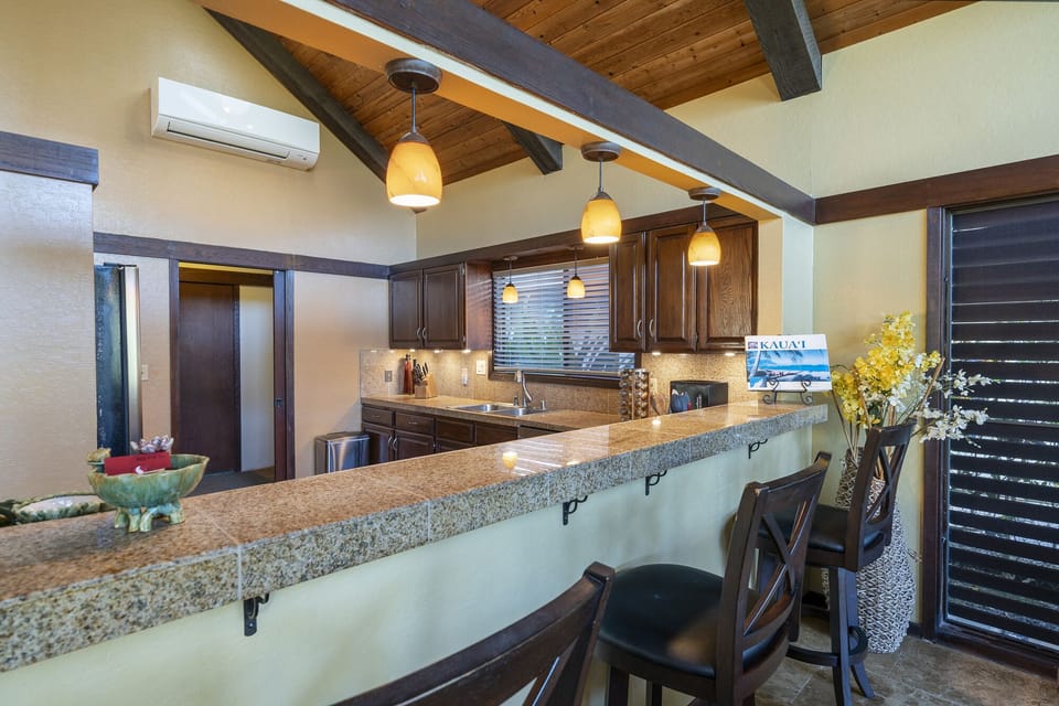 The breakfast bar provides seating for three people.