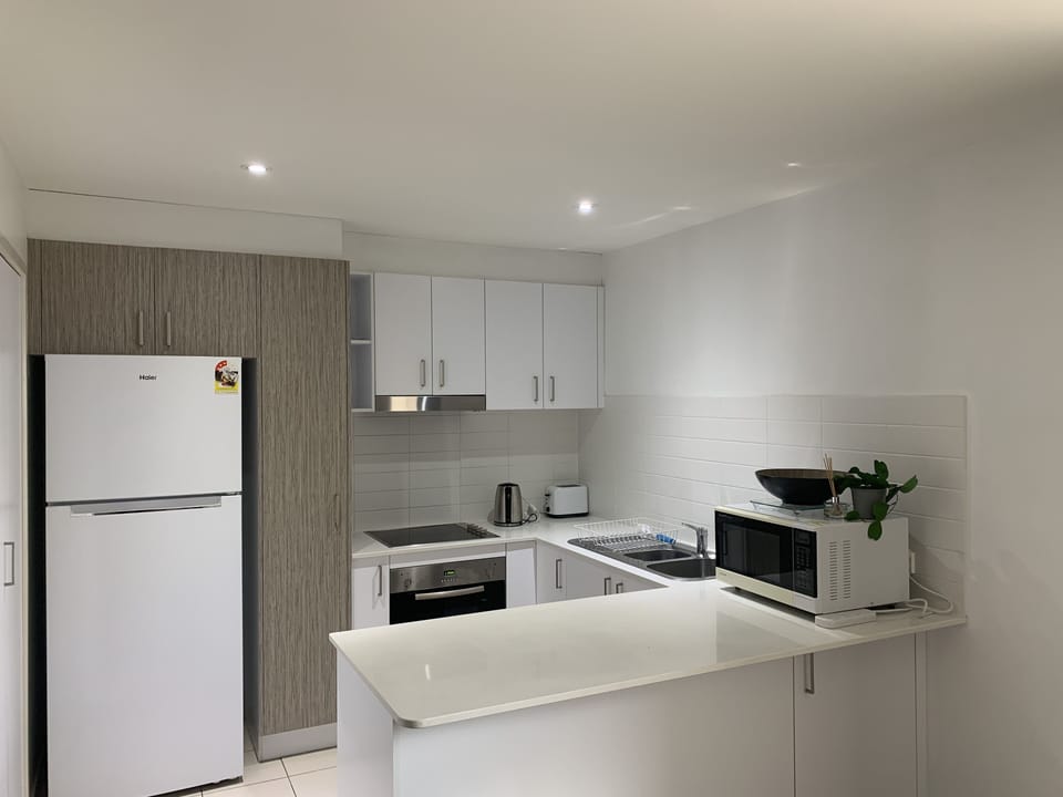 Modern fully equipped kitchen includes stove, oven, dishwasher, fridge
