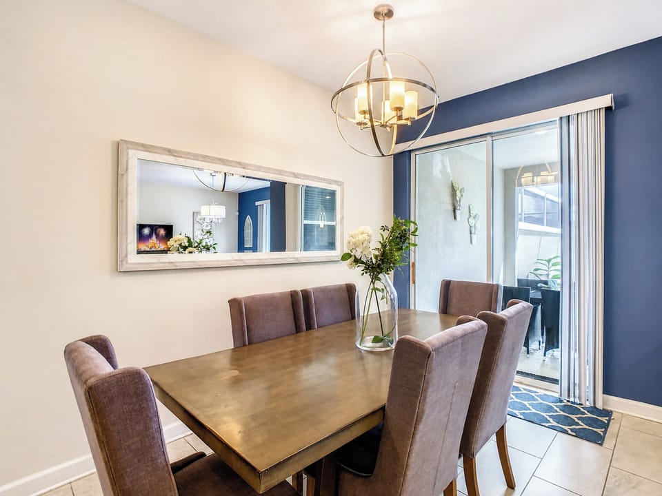 Elegant Dining Area with Modern Chandelier and Patio Access