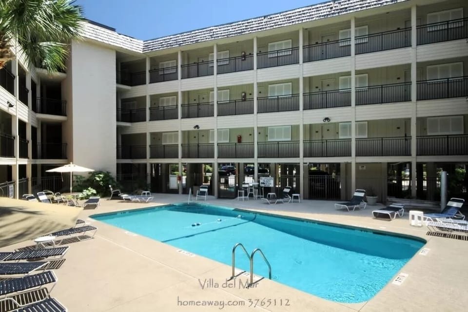 Pool with lounge chairs and umbrellas!