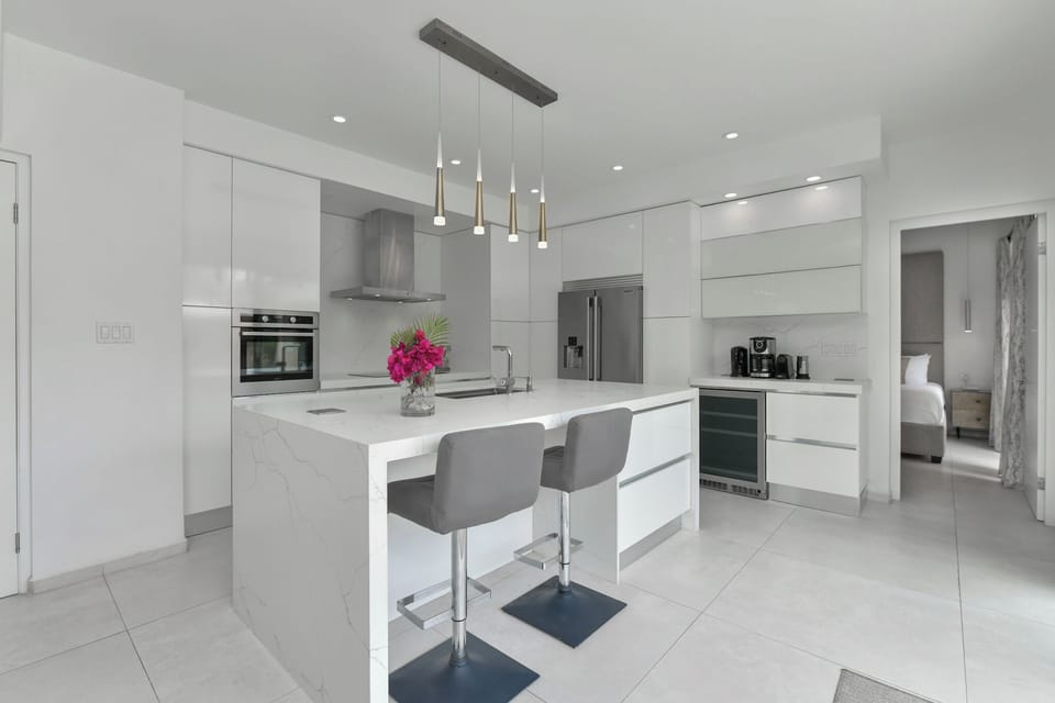 Fully equipped modern kitchen and entrance to main floor King bedroom
