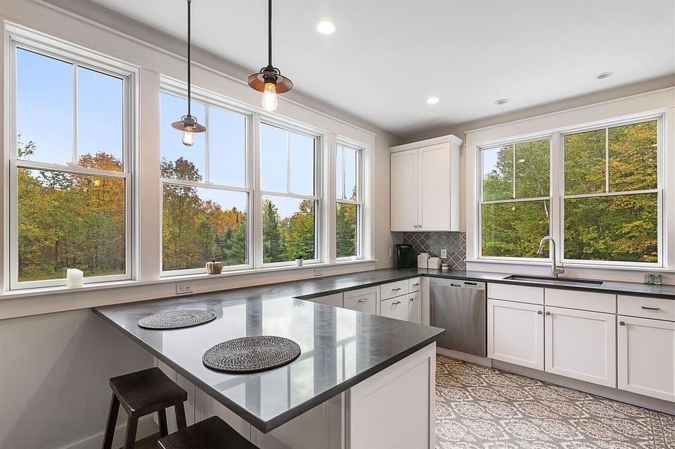 Natural light streams through the gleaming kitchen windows