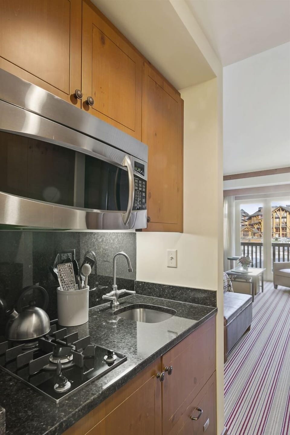 Kitchenette features 2 burner gas stovetop, microwave, dishwasher and hotel size fridge