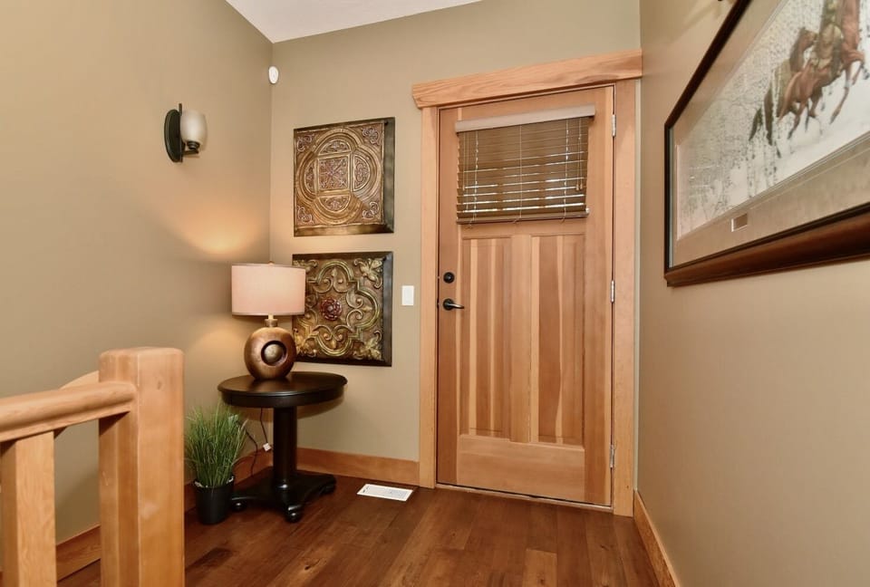 This door (at top floor landing) leads to a cozy, private deck that faces south.
