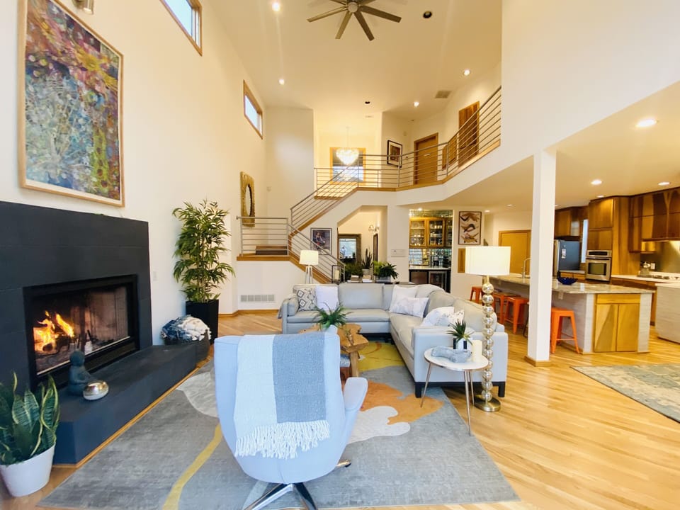 A sunlit haven with vaulted ceilings and cozy fireplace, perfect for gatherings
