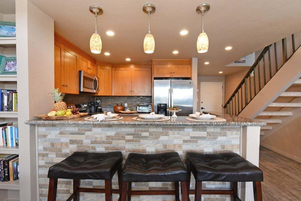 Modern convenience meets sleek design at the breakfast bar. High-end finishes and comfortable seating make this a central hub for quick bites or evening drinks.