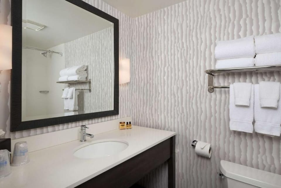 Refresh effortlessly with bright vanity space and plush towels.