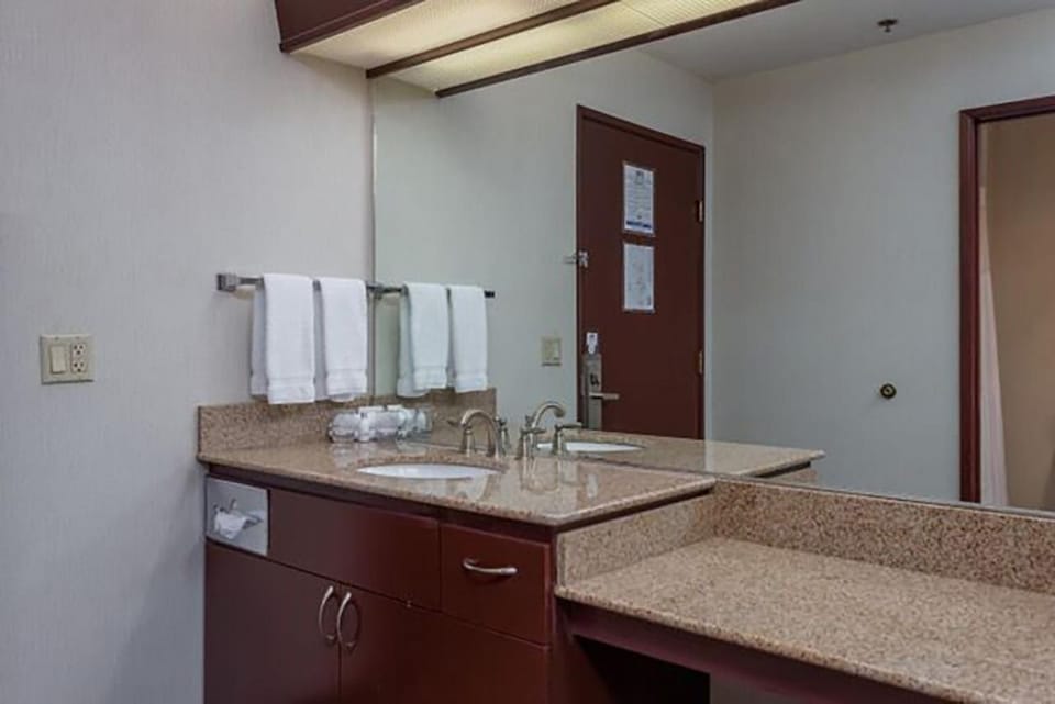 Freshen up at the roomy vanity with bright mirror lighting.