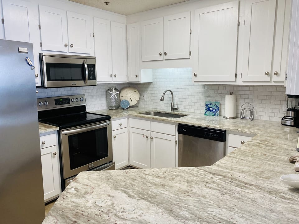 Fully equipped kitchen with stainless steel appliances and granite counter top