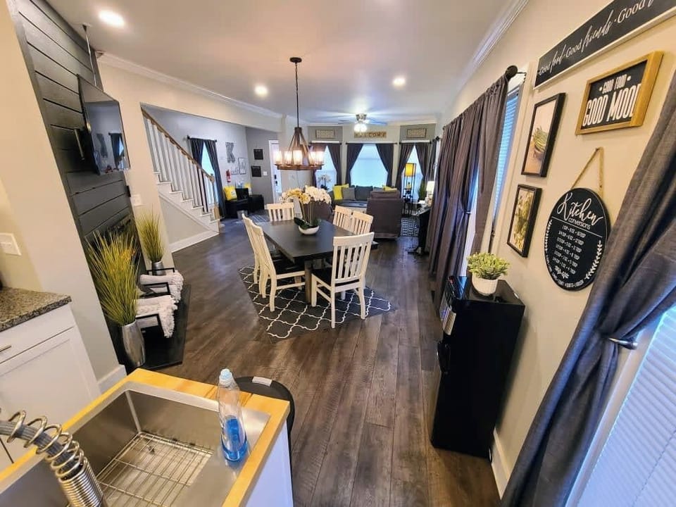 View of dining room, living room and entry while standing in the kitchen