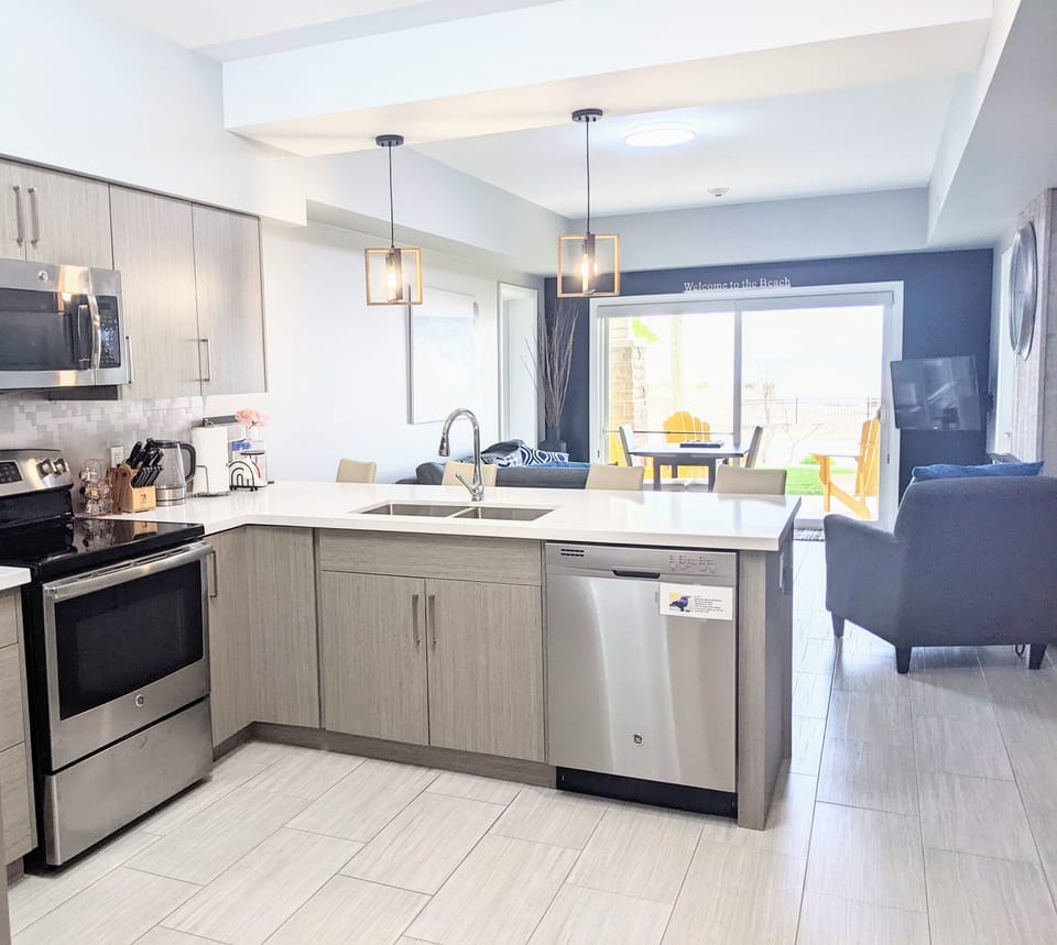 Full kitchen off sitting area, with views of the beach 