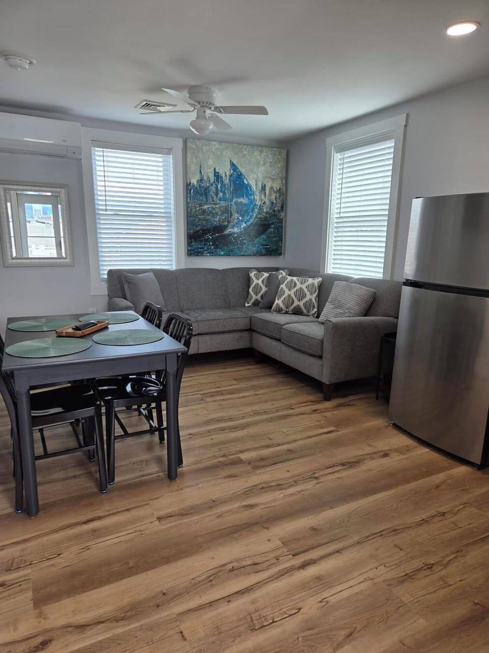 open concept kitchen/dining/living area with climate control and smart tv