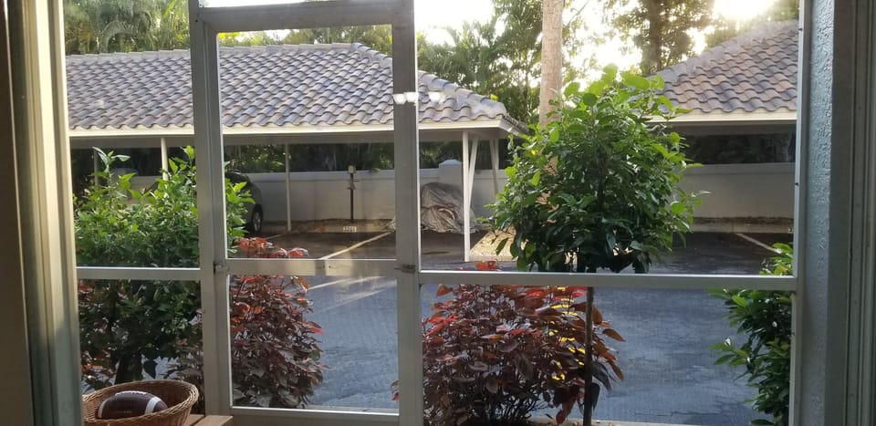 Screened lanai in the rear.  Steps away to covered parking space. 