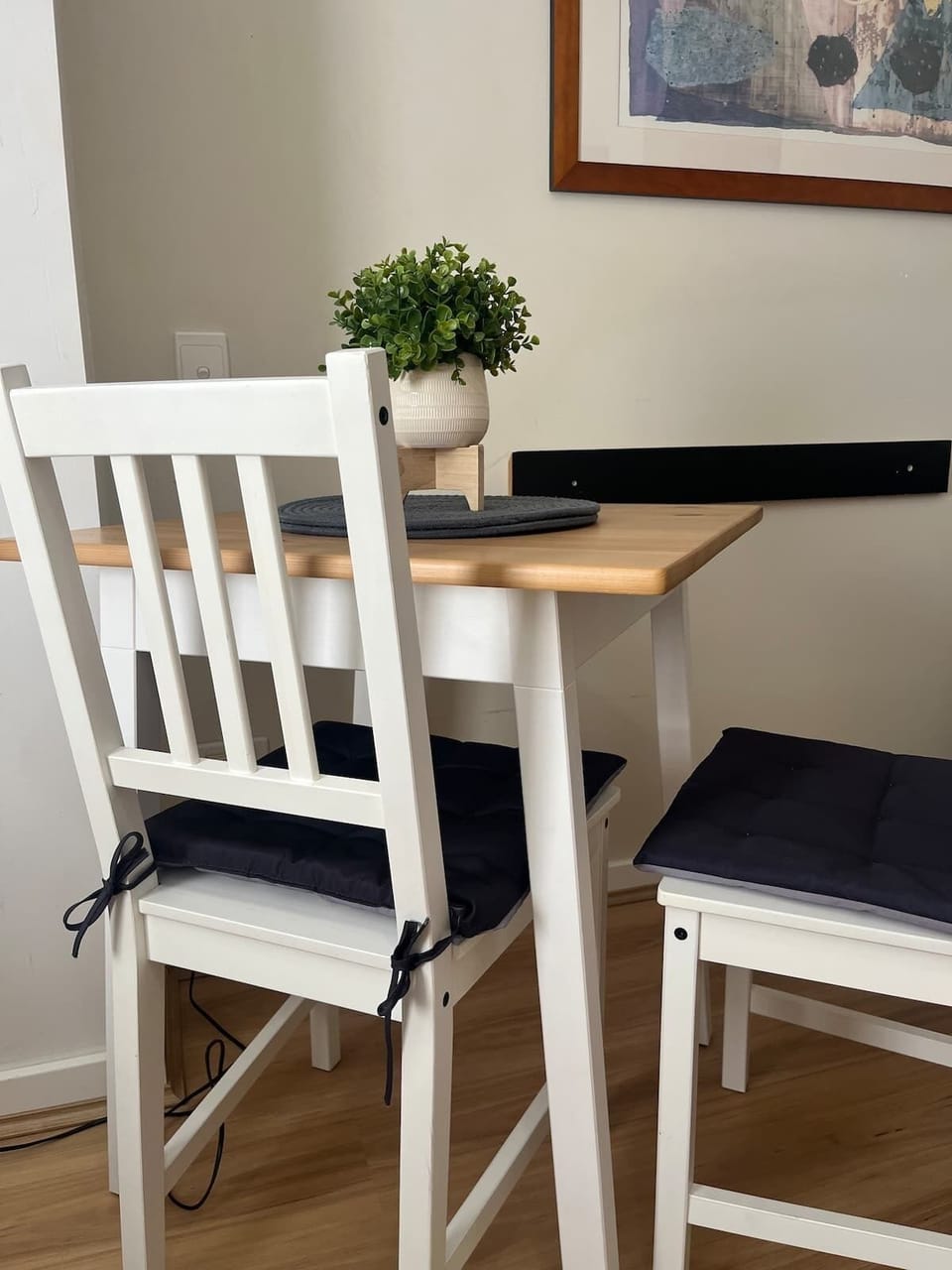 Enjoy a cozy meal or a productive workspace at our charming wooden table, thoughtfully designed with comfortable seating for two.