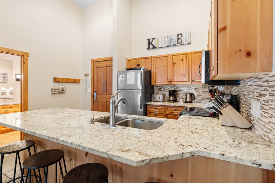 Your spacious kitchen invites culinary adventures with granite countertops, modern appliances, and rustic wood cabinets creating the perfect blend of comfort and functionality.