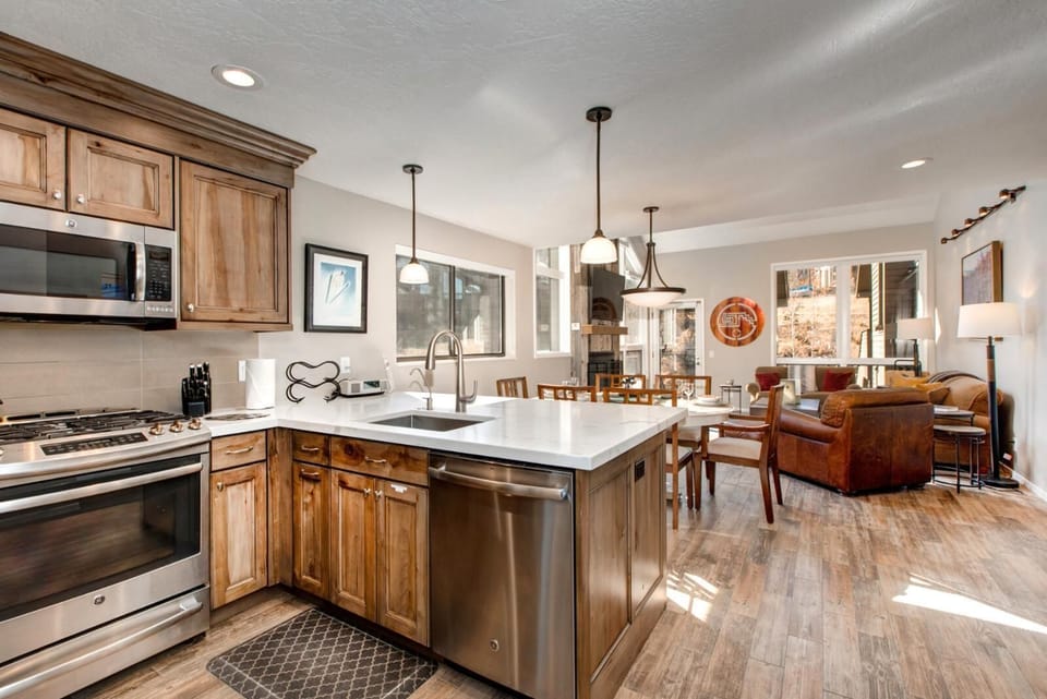 This alternate kitchen angle shows ample prep space, cabinetry, and a view to the adjacent dining area.