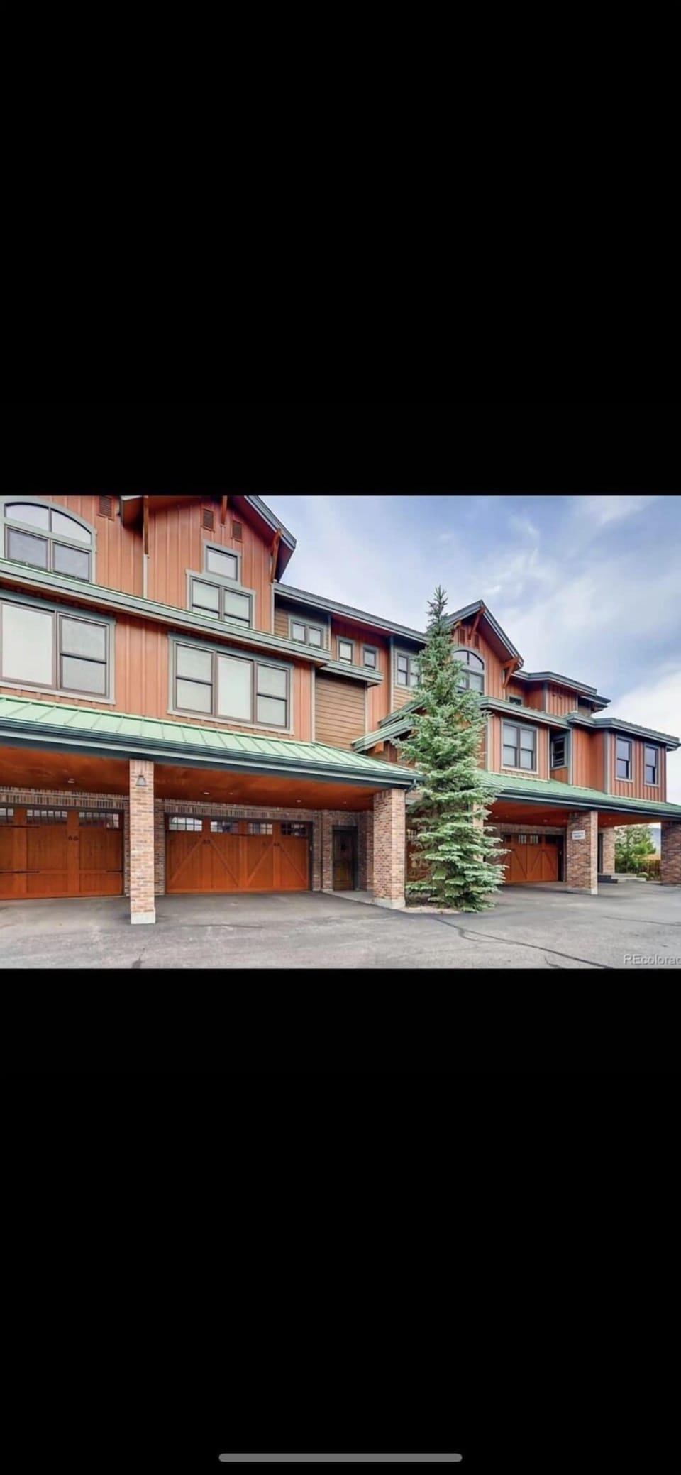 Front exterior featuring 2 car heated garage + 2 car port. 