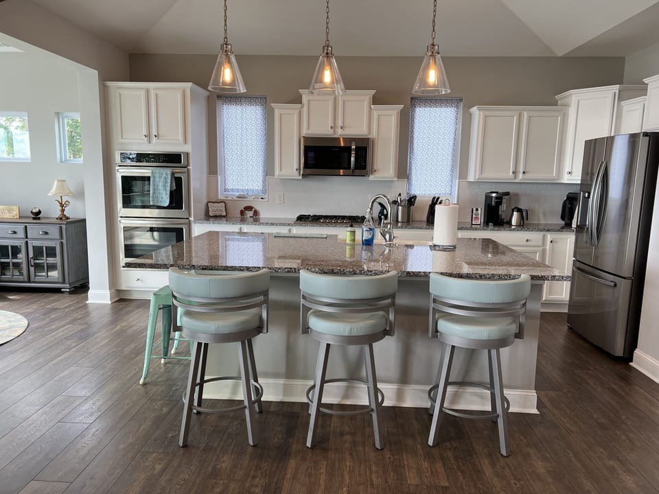 Huge island to gather. Chefs kitchen stocked with pans knives etc. Double ovens