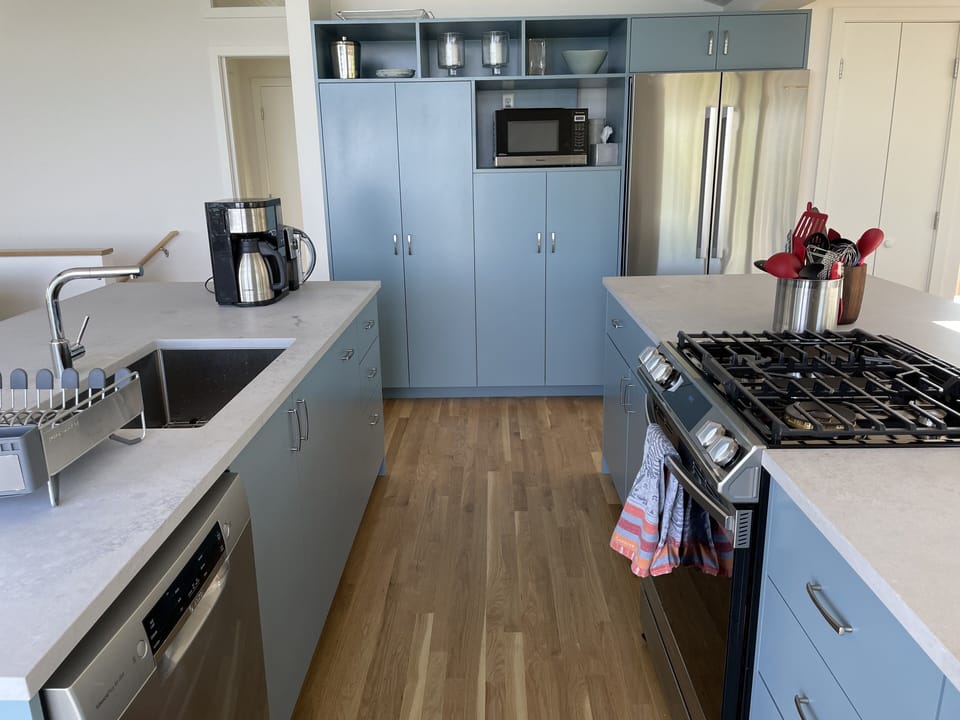 Cooking area, cupboards and fridge-freezer.