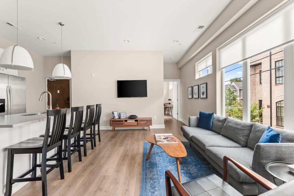 Open living room with beautiful large windows  and island seating