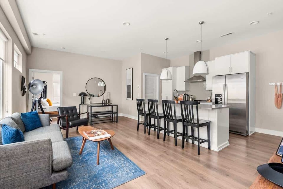 Open living room with beautiful large windows  and island seating