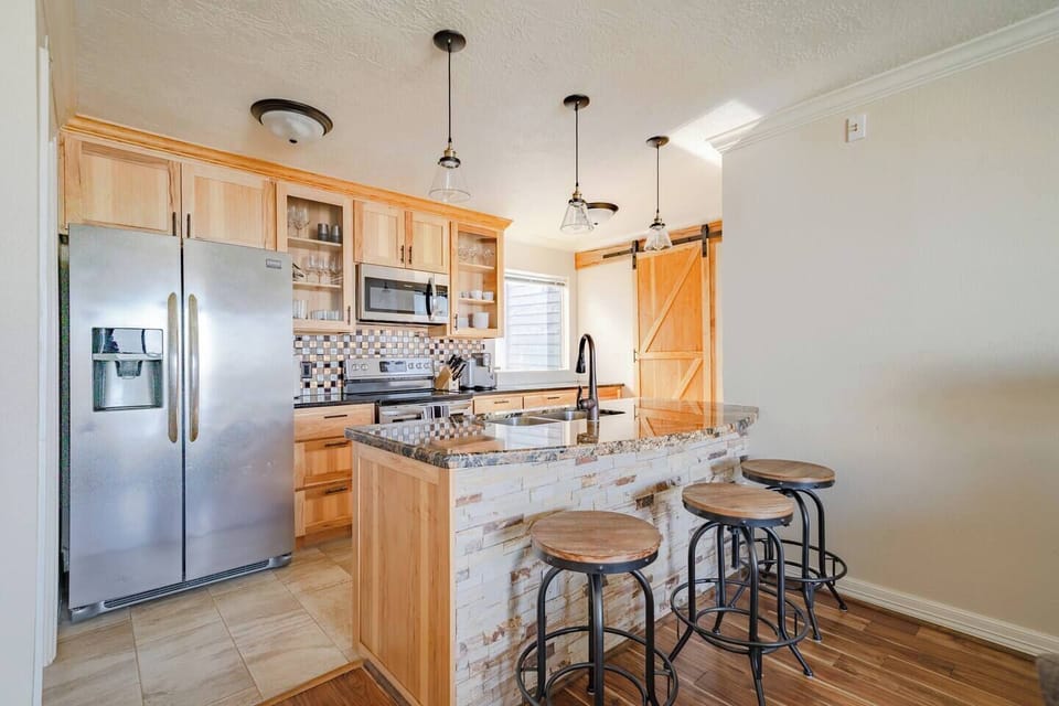 A fully equipped kitchen with modern appliances and rustic charm.