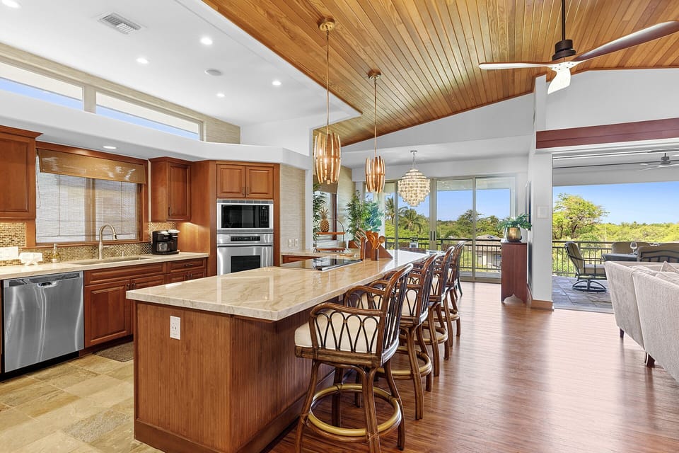 Open concept kitchen and dining area with bar seating for quick breakfasts