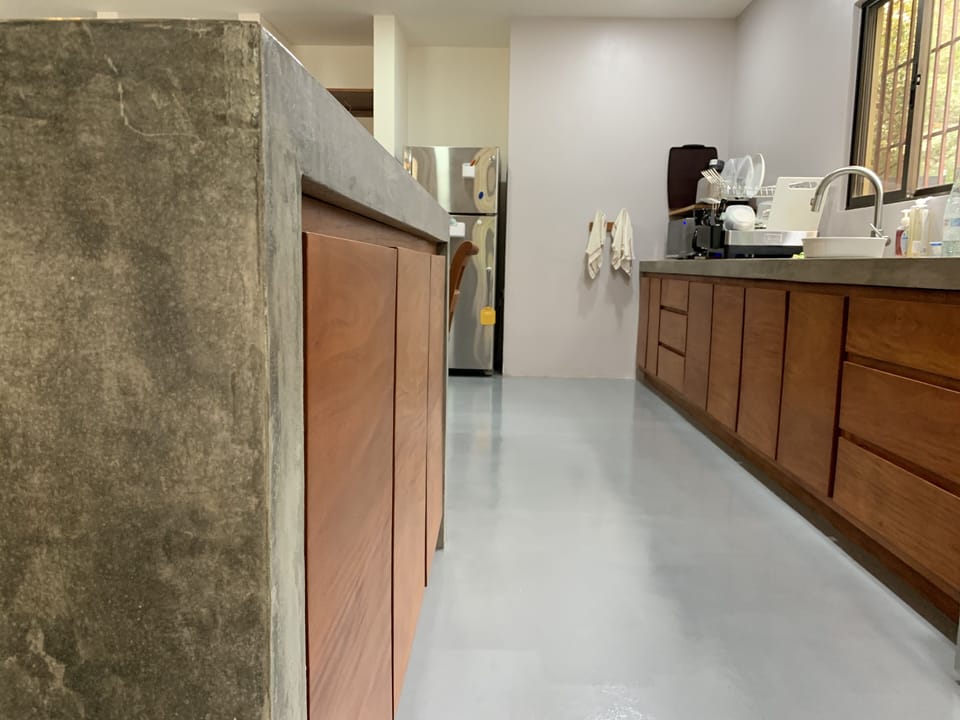 Custom concrete island, counters and wood cabinetry