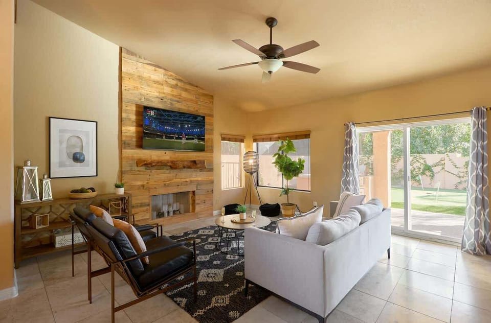Bright open living space featuring a smart TV, designer furnishings, and access to the backyard.