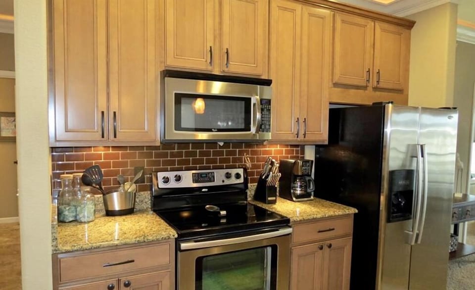 Cupboards have pizza pans, baking dishes, muffin tins, variety of utensils etc