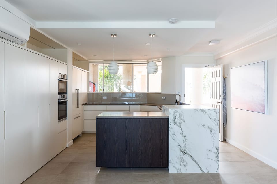 Standard and convection ovens, induction cooktop, dishwasher and coffee machine