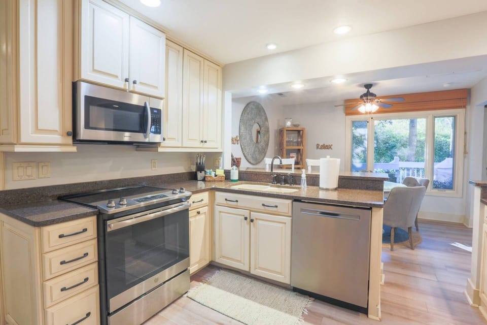 The renovated kitchen boasts stainless steel appliances, white cabinets and granite countertops.