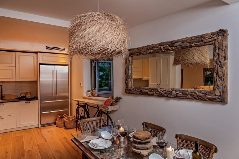A view of the luxuriously decorated dining table with chairs next to the kitchen in the luxury villa Brač