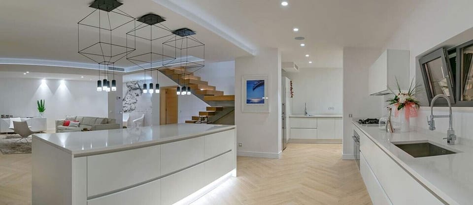 Comfortable, modernly equipped kitchen of Croatian luxury villa with pool on Brac with white elements and large kitchen island