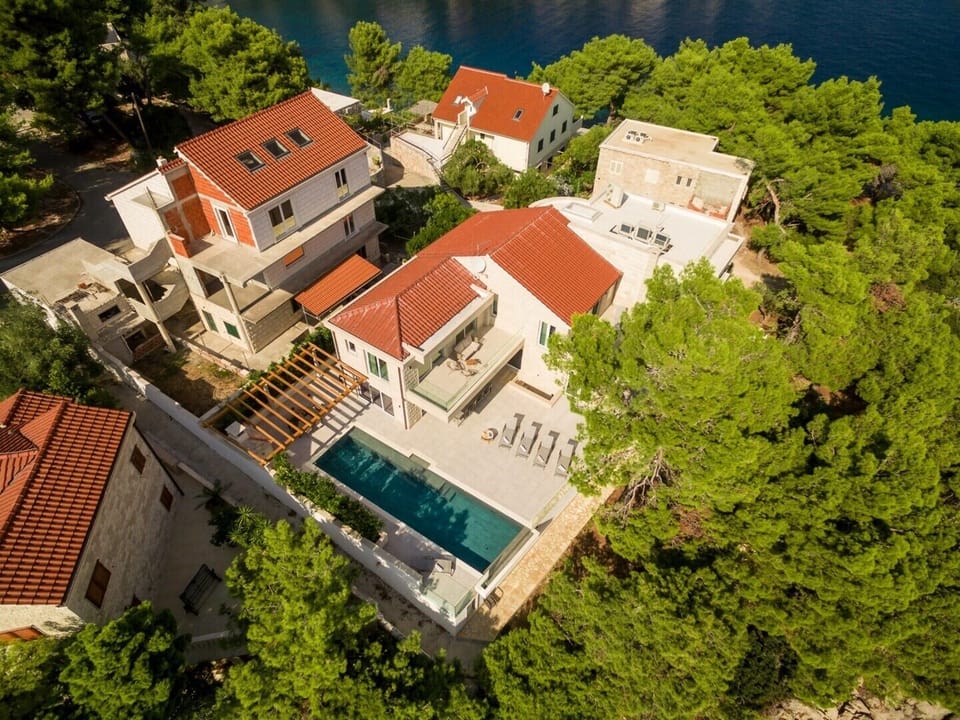 Aerial view of the Croatian luxury beachfront villa White Bellezza with private pool on Brac island for vacation with friends