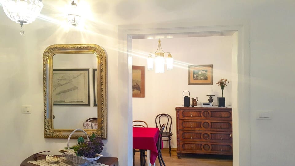 The interior of the villa Beach House Orebic with pool with a wooden chest of drawers, a table and a mirror