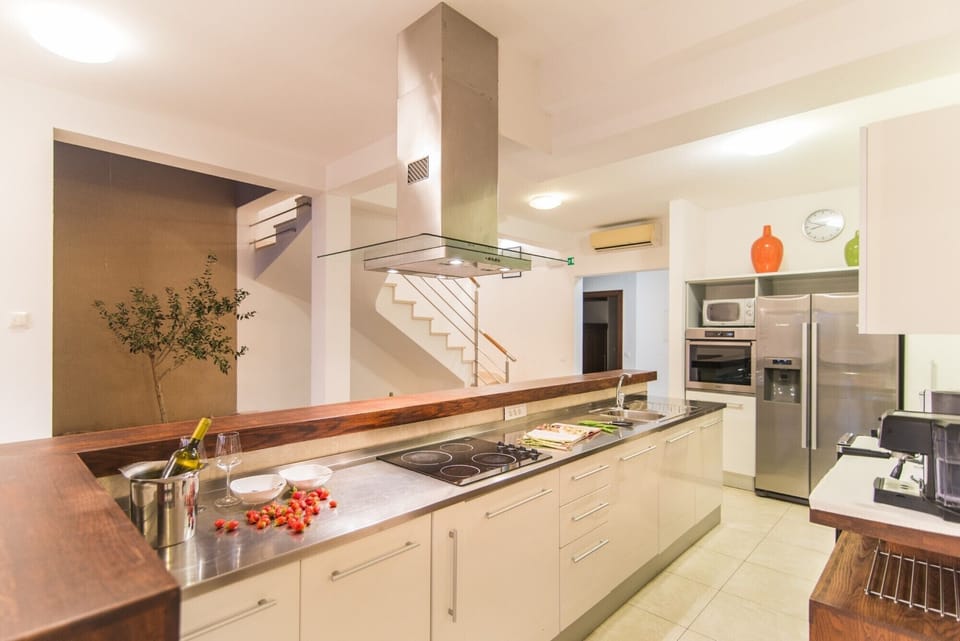 Electric stove in a modern kitchen of a Croatia luxury villa Mediterranean with heated pool and parking
