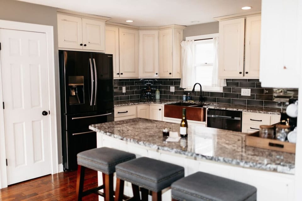 Kitchen with island seating and full appliances.
