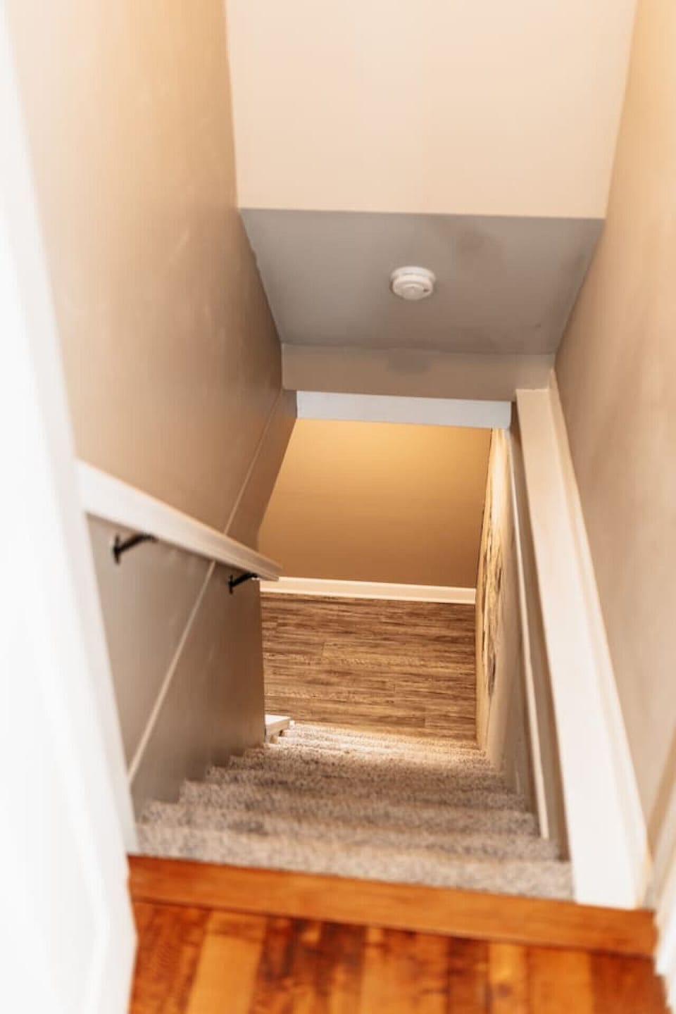 Staircase leading to the basement bedroom with two full beds.
