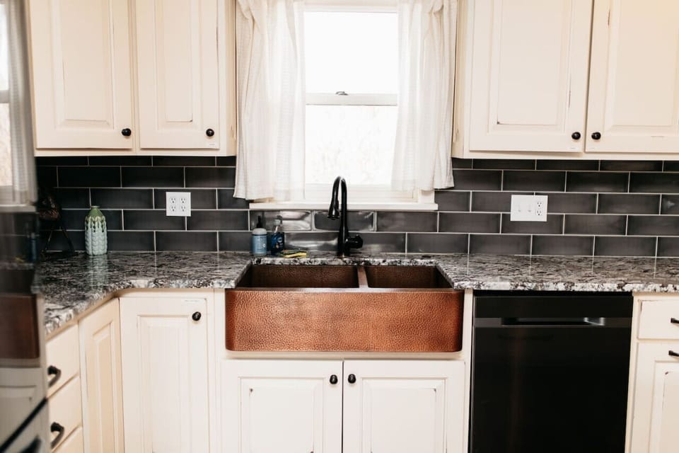 Kitchen with copper farmhouse sink.