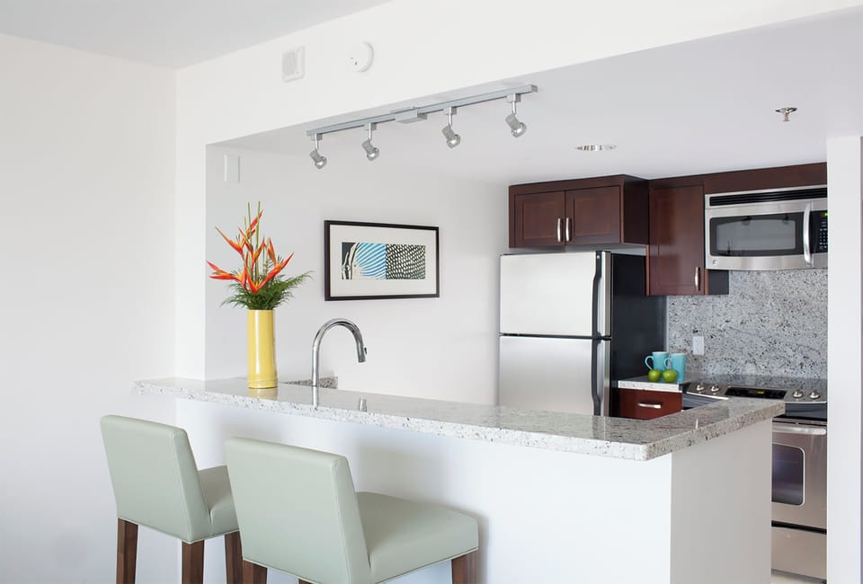 Settle in at the sleek breakfast bar, where granite countertops and modern appliances make your morning coffee feel like a treat. The space is bright, open, and ready for your favorite recipes.