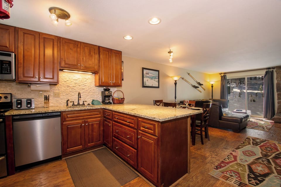 Your fully-equipped kitchen flows seamlessly into the cozy living area, perfect for cooking memorable meals together.