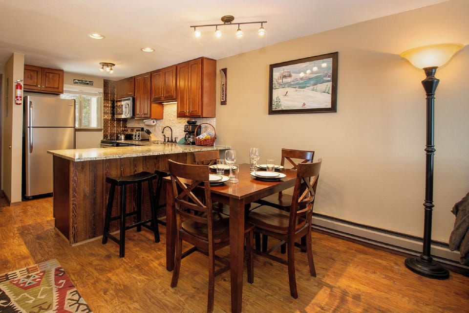 Your open-concept kitchen and dining area features rich wood cabinets, granite countertops, and a cozy dining table for home-cooked meals.