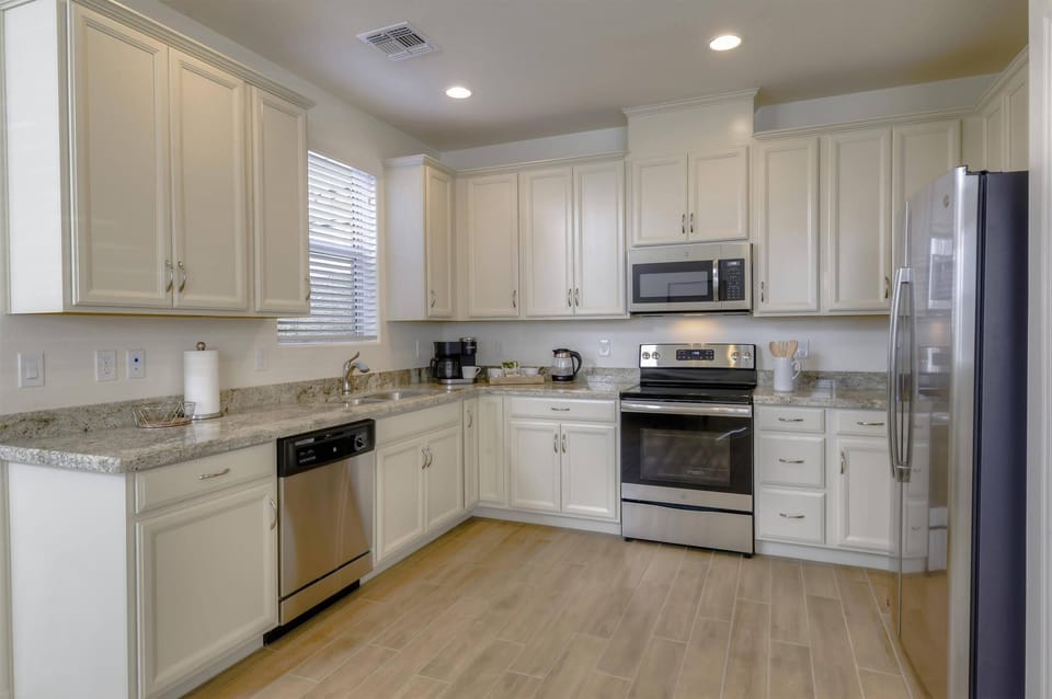 Fully equipped kitchen with stainless steel appliances and granite countertops