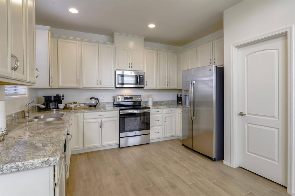 Fully equipped kitchen with stainless steel appliances and granite countertops