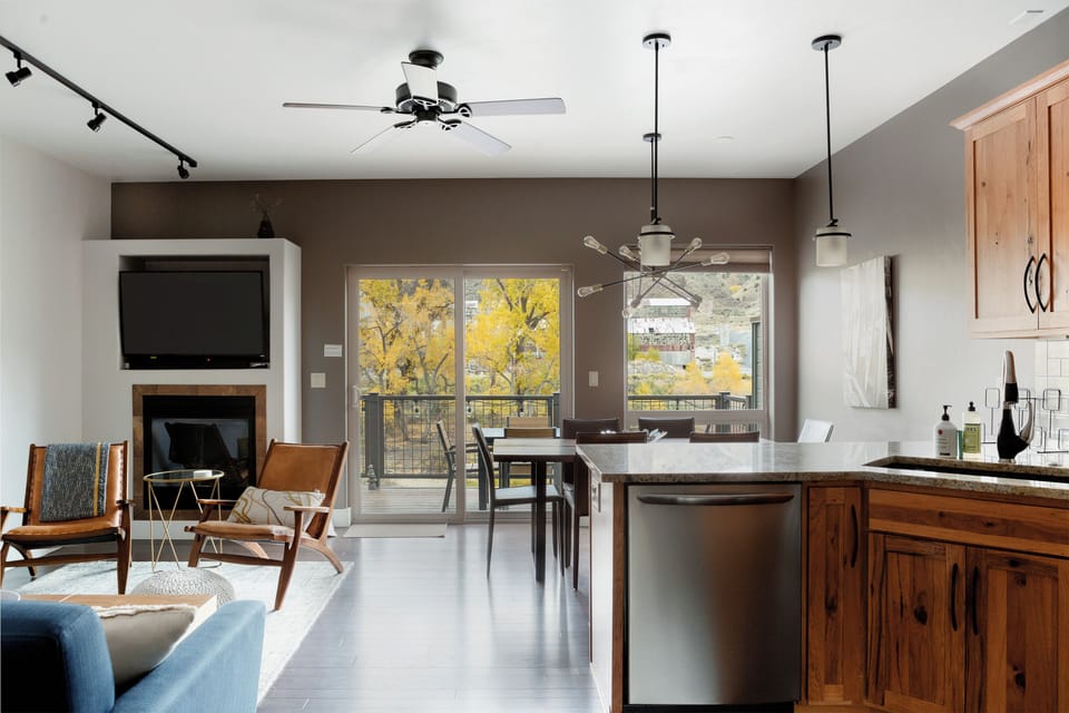 View of living, dining and kitchen area leading out to patio on riverside