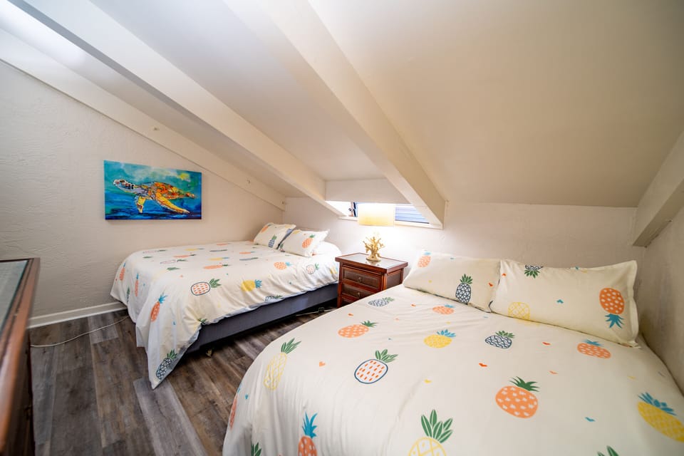 Back room of loft with one queen and one full.  Room has a door for privacy.