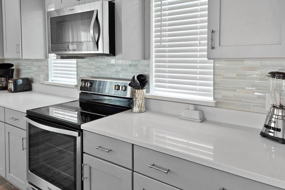 Kitchen has beautiful counters and tile backsplash!