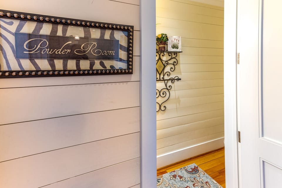 Hallway leading into a half bathroom on the middle floor