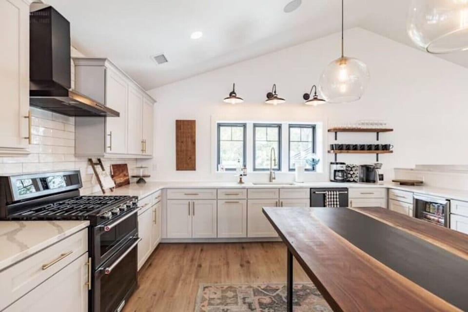 Brand new KitchenAid appliances, quartz countertops, and a custom built island.